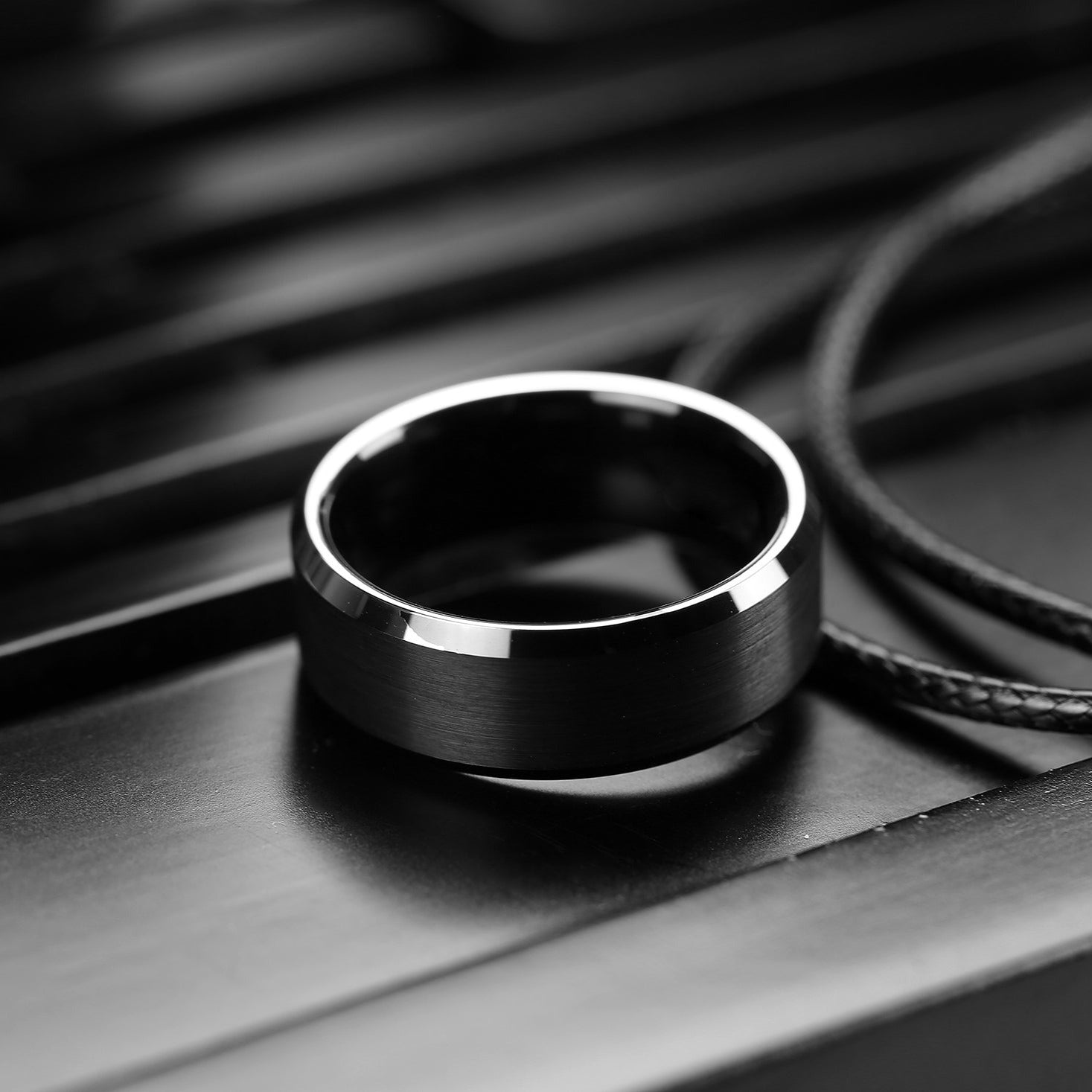Black ring on a dark surface with a blurred background