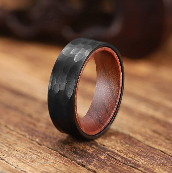Close-up of hammered finish tungsten carbide ring with wood interior