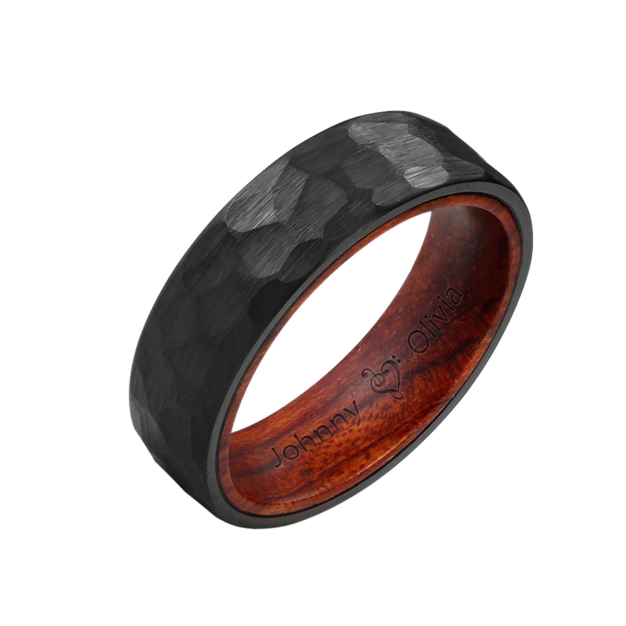 A black tungsten carbide band with a hammered texture on the surface and a brown KOA wood inlaid band on the inside.