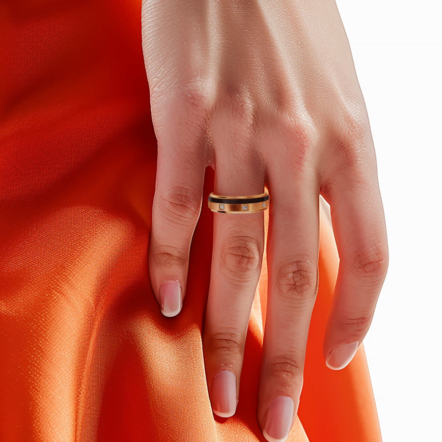 Hand wearing a ring on an orange fabric background